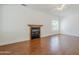 Living room with a fireplace, ceiling fan, and window at 1031 W Longhorn Dr, Chandler, AZ 85286