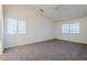 Large main bedroom with carpet, vaulted ceiling, and natural light from two windows at 1031 W Longhorn Dr, Chandler, AZ 85286