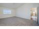 Spacious main bedroom featuring neutral carpet, vaulted ceiling, and ensuite bathroom entry at 1031 W Longhorn Dr, Chandler, AZ 85286