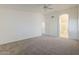 Large main bedroom with neutral carpet, entry to the main bathroom, and ceiling fan at 1031 W Longhorn Dr, Chandler, AZ 85286