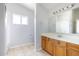 Bathroom featuring a vanity with wood cabinets and tile flooring at 10334 E Diamond Ave, Mesa, AZ 85208