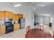 Bright kitchen with tile flooring, stainless steel refrigerator, and wood cabinetry at 10334 E Diamond Ave, Mesa, AZ 85208