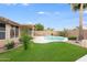 Inviting backyard features a sparkling pool, lush lawn, covered patio, and mature landscaping, perfect for outdoor relaxation and entertainment at 10845 W Quail Ave, Peoria, AZ 85373