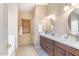 Bathroom featuring double sinks, a window, and wood cabinets at 10845 W Quail Ave, Peoria, AZ 85373