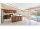 Bright kitchen features stainless appliances, a center island, and a view of the backyard pool at 10845 W Quail Ave, Peoria, AZ 85373