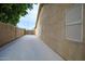 Concrete side yard with privacy wall provides ample space and potential for customization or additional storage solutions at 10845 W Quail Ave, Peoria, AZ 85373