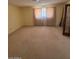 Spacious bedroom filled with light, neutral carpet, and large window at 121 E Ivanhoe St, Gilbert, AZ 85295