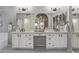 Bright bathroom featuring a double vanity with black hardware, gray hexagon floor tiles, and large mirror at 1231 W Mediterranean Dr, Gilbert, AZ 85233