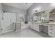 A bathroom featuring a glass shower, garden tub, and double vanity with gray hexagon floor tiles at 1231 W Mediterranean Dr, Gilbert, AZ 85233
