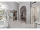 Bathroom leading to bedroom, featuring walk-in closet with mirrored doors, and gray hexagon floor tiles at 1231 W Mediterranean Dr, Gilbert, AZ 85233
