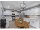 Kitchen with white cabinets, stainless steel appliances, and a round wood table at 1231 W Mediterranean Dr, Gilbert, AZ 85233