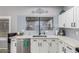 Close-up of kitchen sink with stainless steel dishwasher, and white countertops at 1231 W Mediterranean Dr, Gilbert, AZ 85233