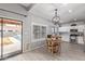 Bright kitchen featuring wood tile floors, a modern light fixture, and white cabinetry at 1231 W Mediterranean Dr, Gilbert, AZ 85233