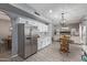 Open kitchen with stainless steel refrigerator and view of the living room at 1231 W Mediterranean Dr, Gilbert, AZ 85233