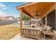 Covered patio with outdoor seating overlooking the refreshing pool and yard at 1231 W Mediterranean Dr, Gilbert, AZ 85233