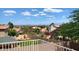 A view from the balcony offers lush landscaping and a community of houses with mountains in the distance at 14021 N 29Th St, Phoenix, AZ 85032