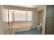 Bright bathroom featuring a corner soaking tub, separate shower, and large vanity at 14021 N 29Th St, Phoenix, AZ 85032