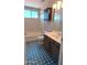 Modern bathroom showcasing blue patterned tile floors, a vanity, and a shower/tub combo at 14021 N 29Th St, Phoenix, AZ 85032