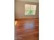 Bedroom with hardwood floors and a window overlooking greenery offers a bright and airy feel at 14021 N 29Th St, Phoenix, AZ 85032