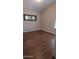 Bedroom featuring wood-look tile flooring, neutral walls, and natural light from a window at 14021 N 29Th St, Phoenix, AZ 85032