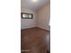 Bedroom with hardwood floors, blinds, and a mirror at 14021 N 29Th St, Phoenix, AZ 85032