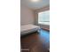 Bedroom with sleek wood floors and a large window providing natural light at 14021 N 29Th St, Phoenix, AZ 85032
