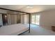 This neutral carpeted bedroom has a ceiling fan and a balcony letting in natural light at 14021 N 29Th St, Phoenix, AZ 85032