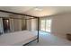 View of a spacious primary bedroom with a canopy bed and french doors at 14021 N 29Th St, Phoenix, AZ 85032