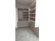 Spacious walk-in closet featuring neutral colors, carpet flooring, and custom built in shelving at 14021 N 29Th St, Phoenix, AZ 85032