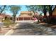 Inviting two-story home with tile roof, lush landscaping, and a two-car garage at 14021 N 29Th St, Phoenix, AZ 85032