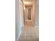Hallway featuring patterned tile flooring and neutral walls, leading to other rooms at 14021 N 29Th St, Phoenix, AZ 85032