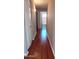 Inviting hallway with gleaming wood floors leading to a bathroom with natural light at 14021 N 29Th St, Phoenix, AZ 85032
