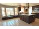 Spacious kitchen featuring tile floors, an island, stainless steel appliances, and backyard views at 14021 N 29Th St, Phoenix, AZ 85032