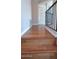 This upstairs landing with hardwood floors and black iron railing leads to a door letting in natural light at 14021 N 29Th St, Phoenix, AZ 85032