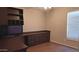Office with built-in shelving, a desk, and natural light from the window offers a productive workspace at 14021 N 29Th St, Phoenix, AZ 85032