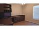 Office space with built-in shelves and desk, laminate flooring, and neutral walls at 14021 N 29Th St, Phoenix, AZ 85032