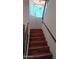 The home's staircase features hardwood steps, with a bright window highlighting the path to the second level at 14021 N 29Th St, Phoenix, AZ 85032
