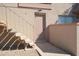Tan apartment exterior features stairs to the second level, light fixture and peach painted door at 14620 N Yerba Buena Way # B, Fountain Hills, AZ 85268