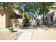 Pathway between homes with desert landscaping, mature trees, and cozy patios, offering a serene environment at 14620 N Yerba Buena Way # B, Fountain Hills, AZ 85268