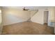 Open living room with ceramic tile flooring, a staircase and a half bathroom at 14620 N Yerba Buena Way # B, Fountain Hills, AZ 85268