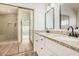 Bathroom featuring a double vanity with granite counters and a tiled shower at 15440 S 38Th St, Phoenix, AZ 85044