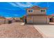 Front exterior of tan two-story home with red rock landscaping and driveway at 15440 S 38Th St, Phoenix, AZ 85044