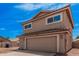 Front exterior of tan two-story home with red rock landscaping and driveway at 15440 S 38Th St, Phoenix, AZ 85044