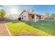 Backyard view with fresh sod, landscaped areas, and view of rear of the home at 1627 W Maplewood St, Chandler, AZ 85286