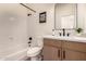 Well-lit bathroom featuring a modern vanity, mirror, and bathtub with shower at 1627 W Maplewood St, Chandler, AZ 85286