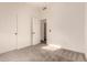 A bright bedroom with plush carpet, white walls, and doors leading to closet and bathroom at 1627 W Maplewood St, Chandler, AZ 85286