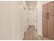 Hallway with sleek floors, neutral walls, and storage cabinets at the end at 1627 W Maplewood St, Chandler, AZ 85286
