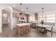 Bright kitchen with stainless appliances, kitchen island with seating, and stylish light fixtures at 1627 W Maplewood St, Chandler, AZ 85286