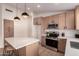 Stylish kitchen with stainless appliances, spacious island, and modern light fixtures at 1627 W Maplewood St, Chandler, AZ 85286