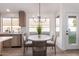 Cozy kitchen nook featuring a modern chandelier, dining table, comfortable chairs and large windows at 1627 W Maplewood St, Chandler, AZ 85286